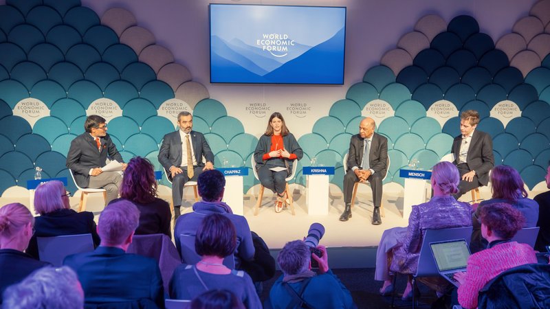 Panelists discuss global issues on an Annual Meeting 2025 stage as journalists and photographers work from the audience during the World Economic Forum in Davos, Switzerland.